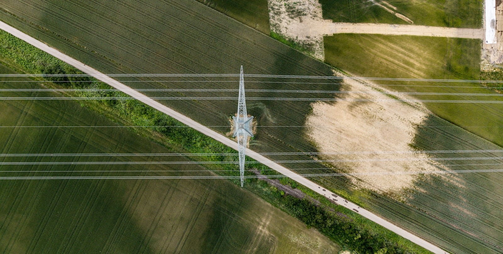 Transmission line corridor crossing arable land, from directly above