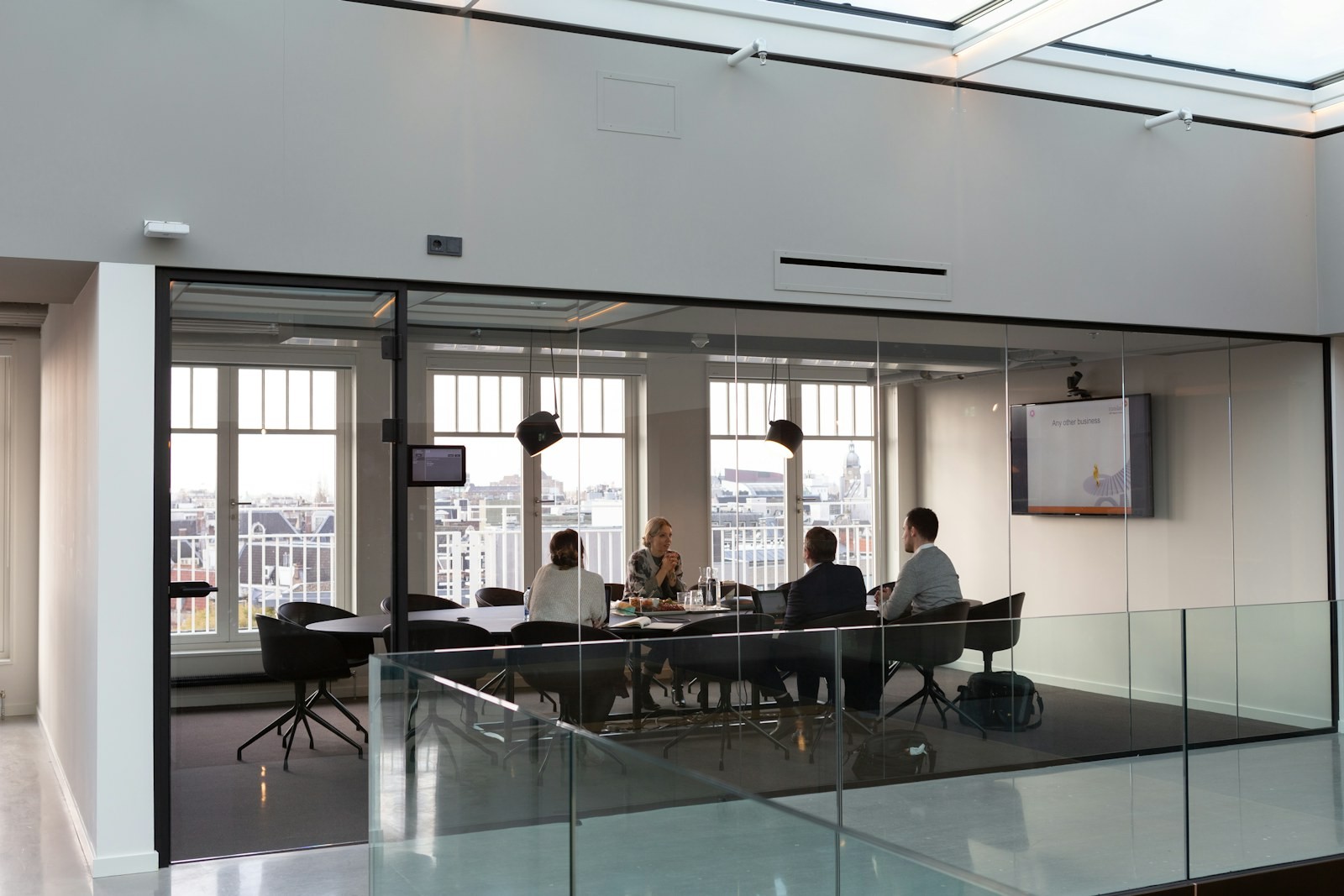 Meeting behind a glass wall in a bright office