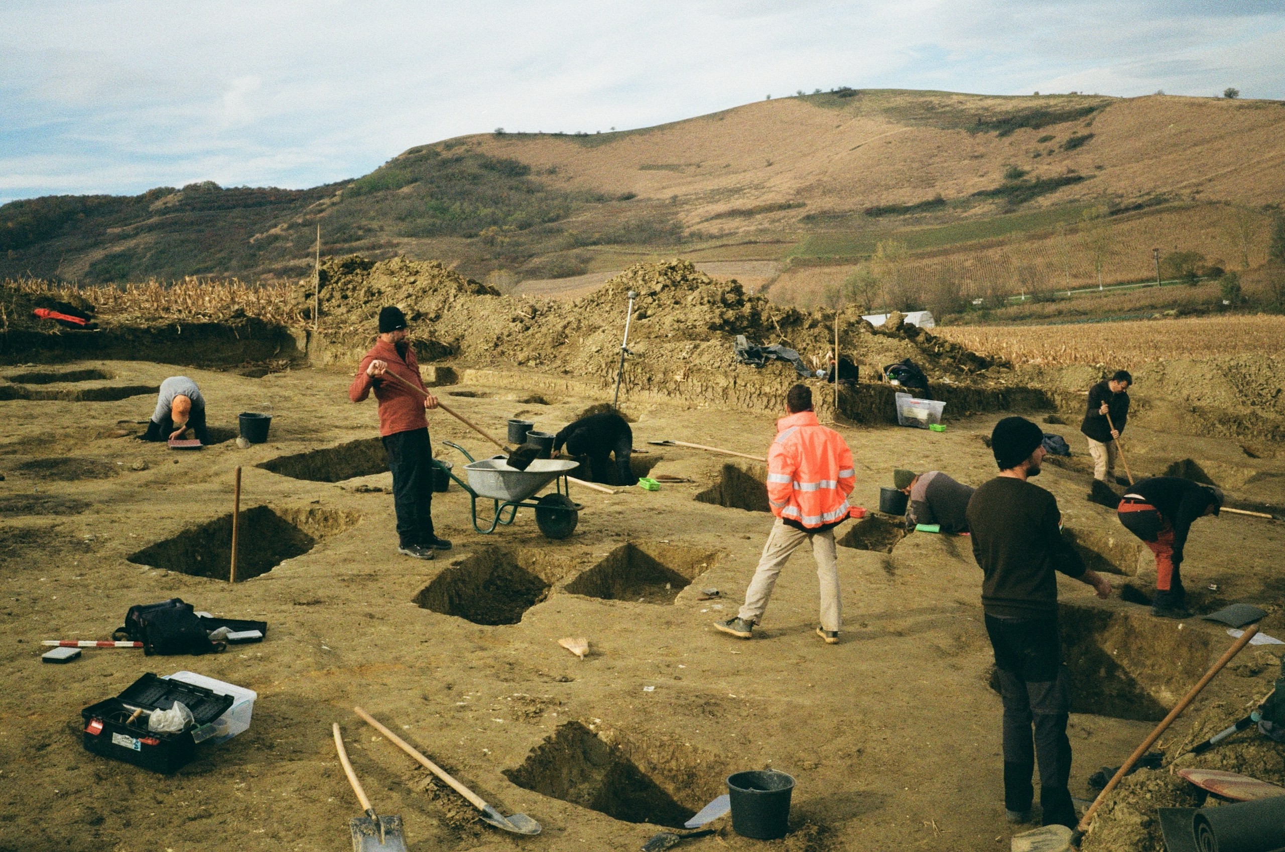 Excavation team working open trenches on a dry hillside