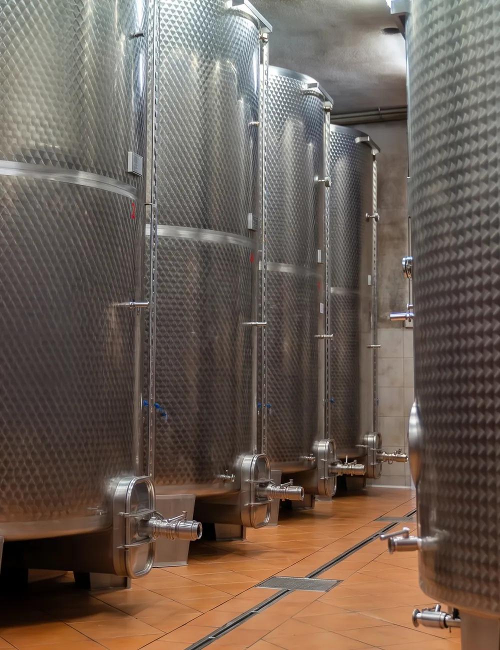 Row of stainless steel tanks in the Jarkovič winery where the wine ferments and matures