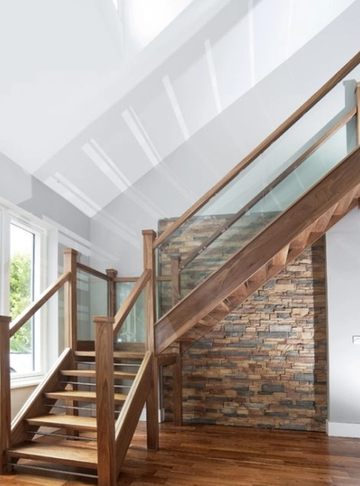 Walnut open riser with stainless steel bars and glass banister. Rectangle 235