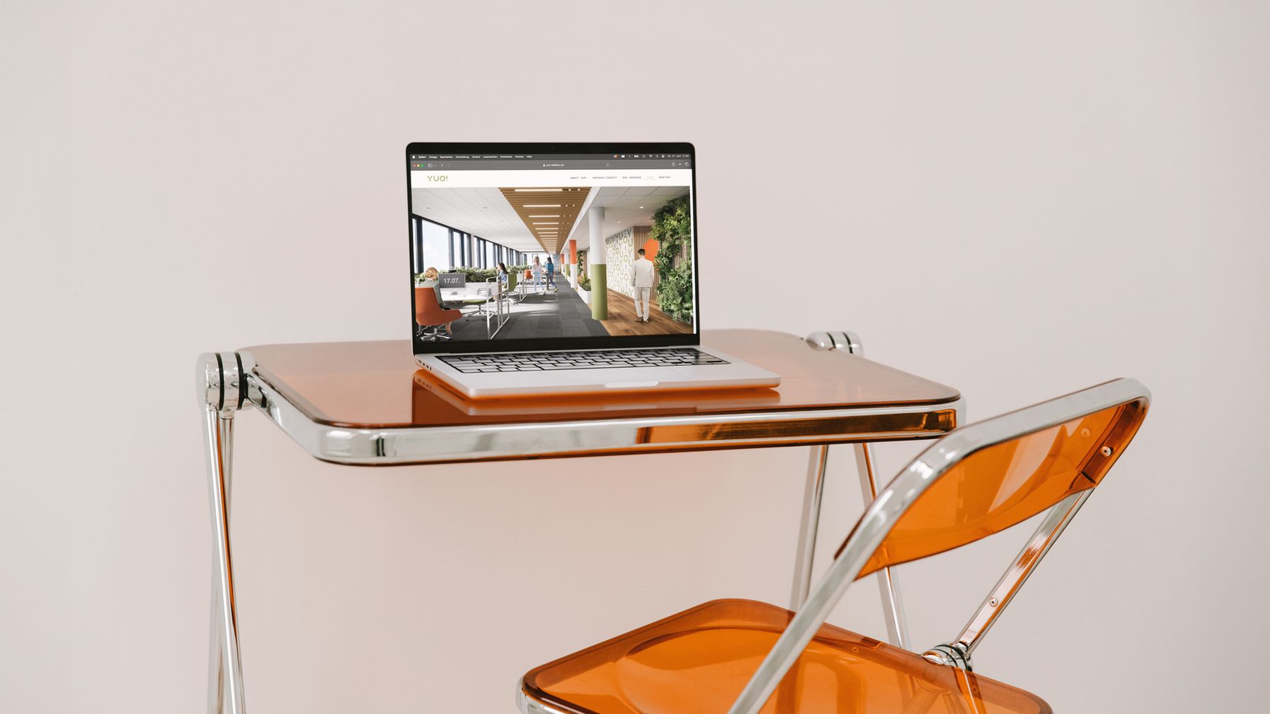 YUO website shown on a laptop with an interior render of the building