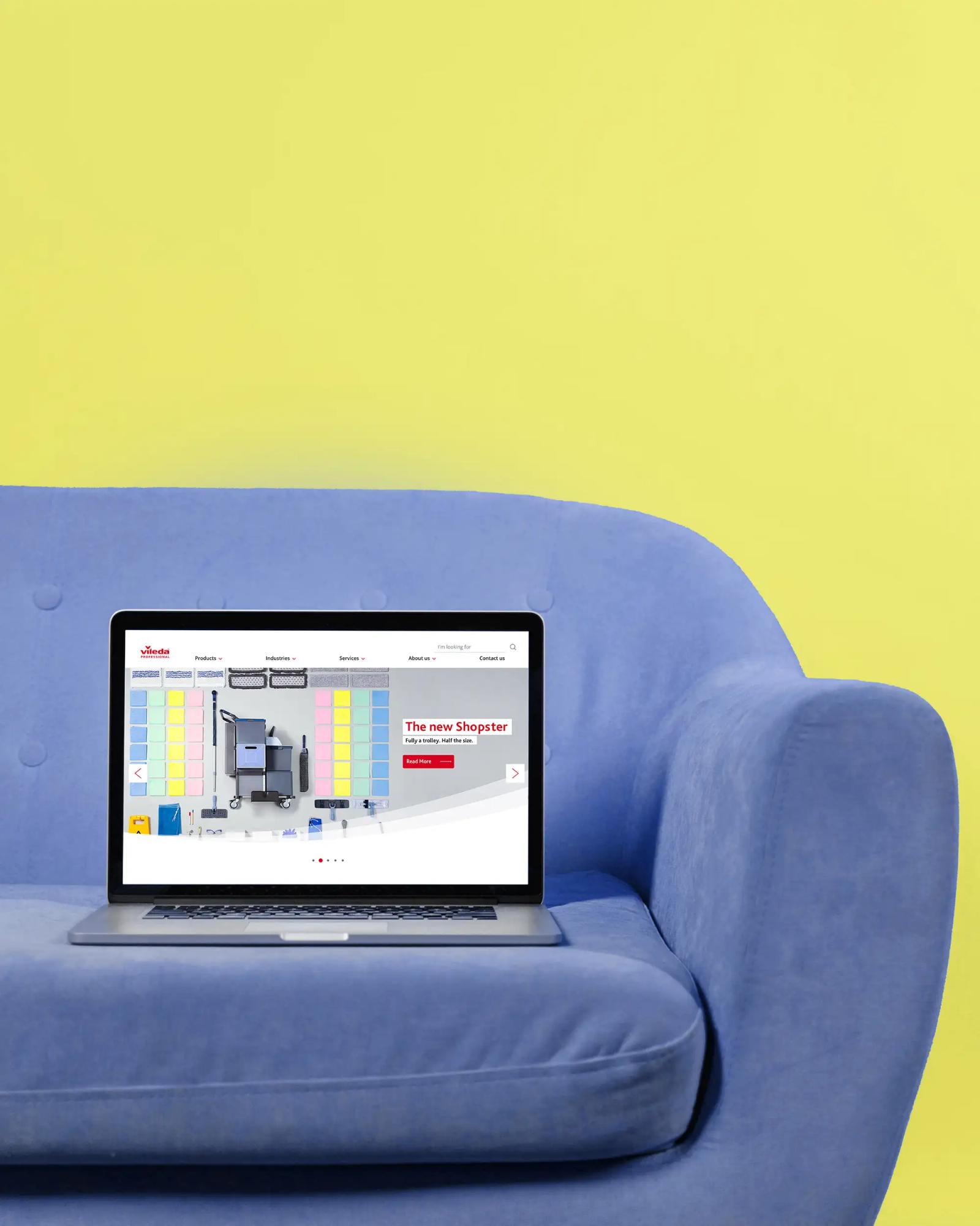 Shopster campaign website shown on a laptop resting on a blue sofa