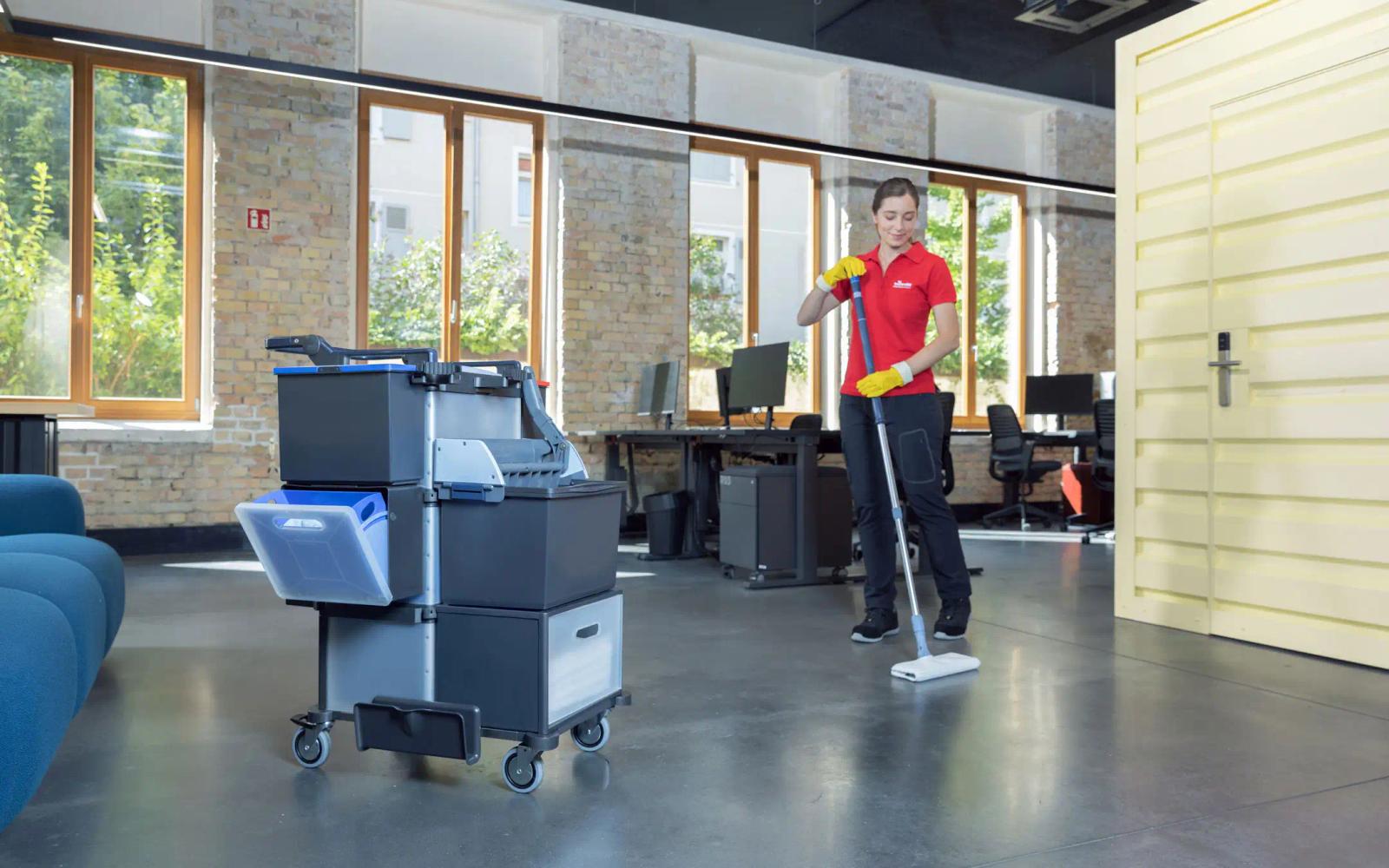 Cleaner mopping an office floor with the compact Shopster trolley beside them