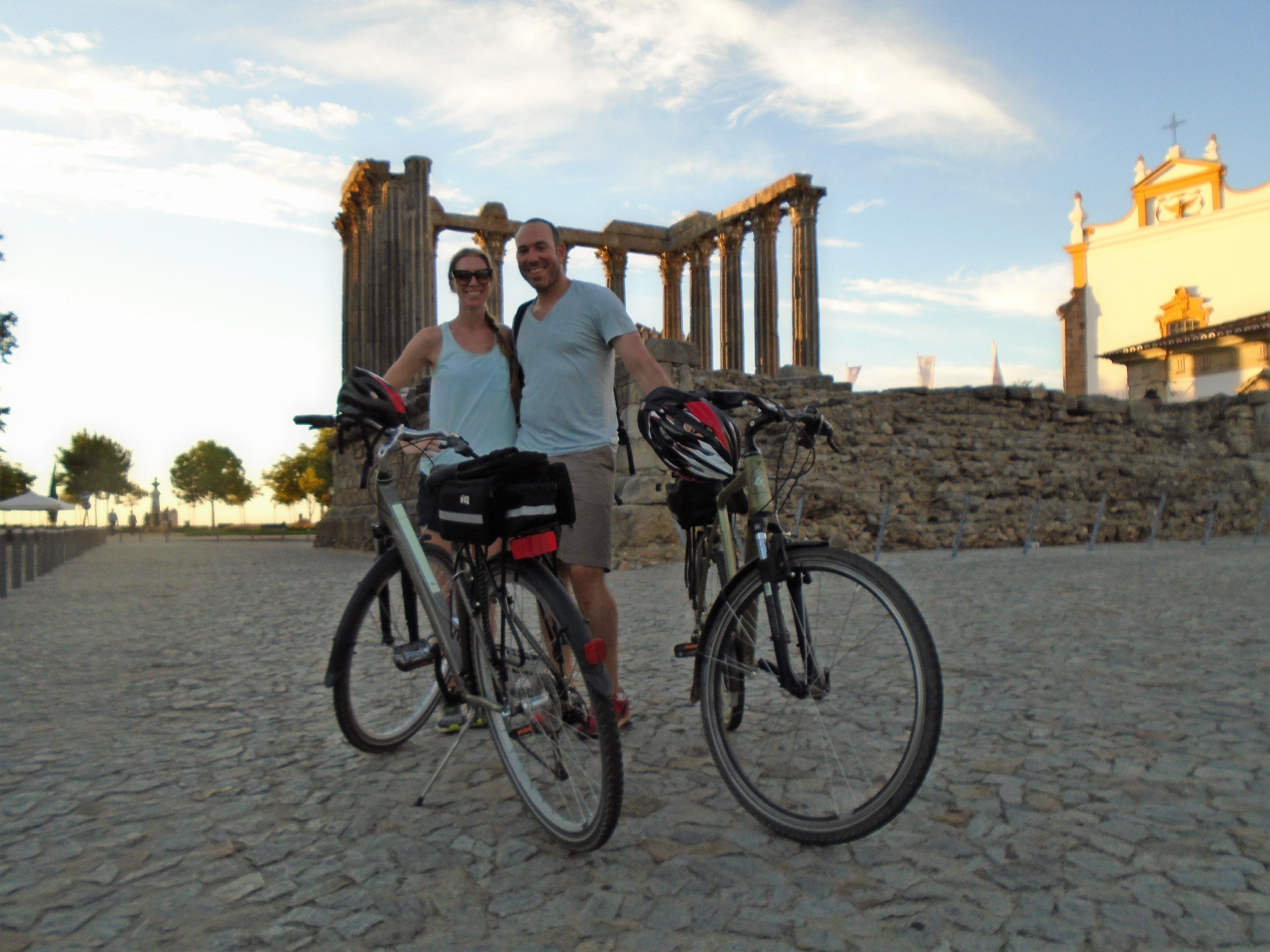 cyclists next to a roman temple