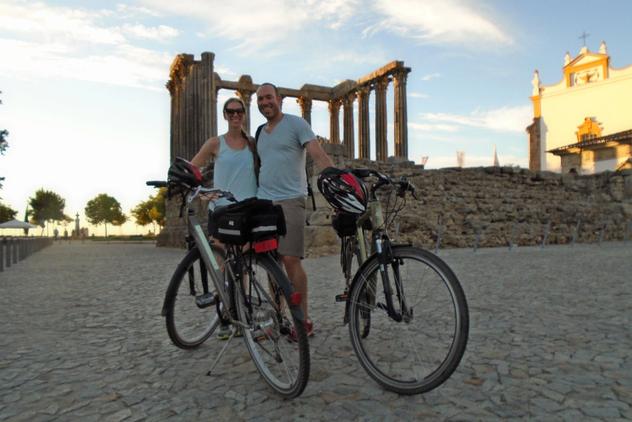 cyclists next to a roman temple