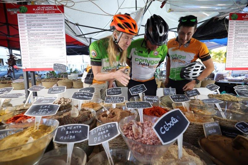 a group of cyclists checking the traditional portuguese market
