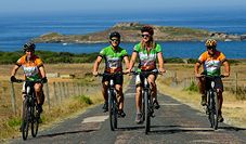 A group of cyclist riding next to Atlantic Portugal coast
