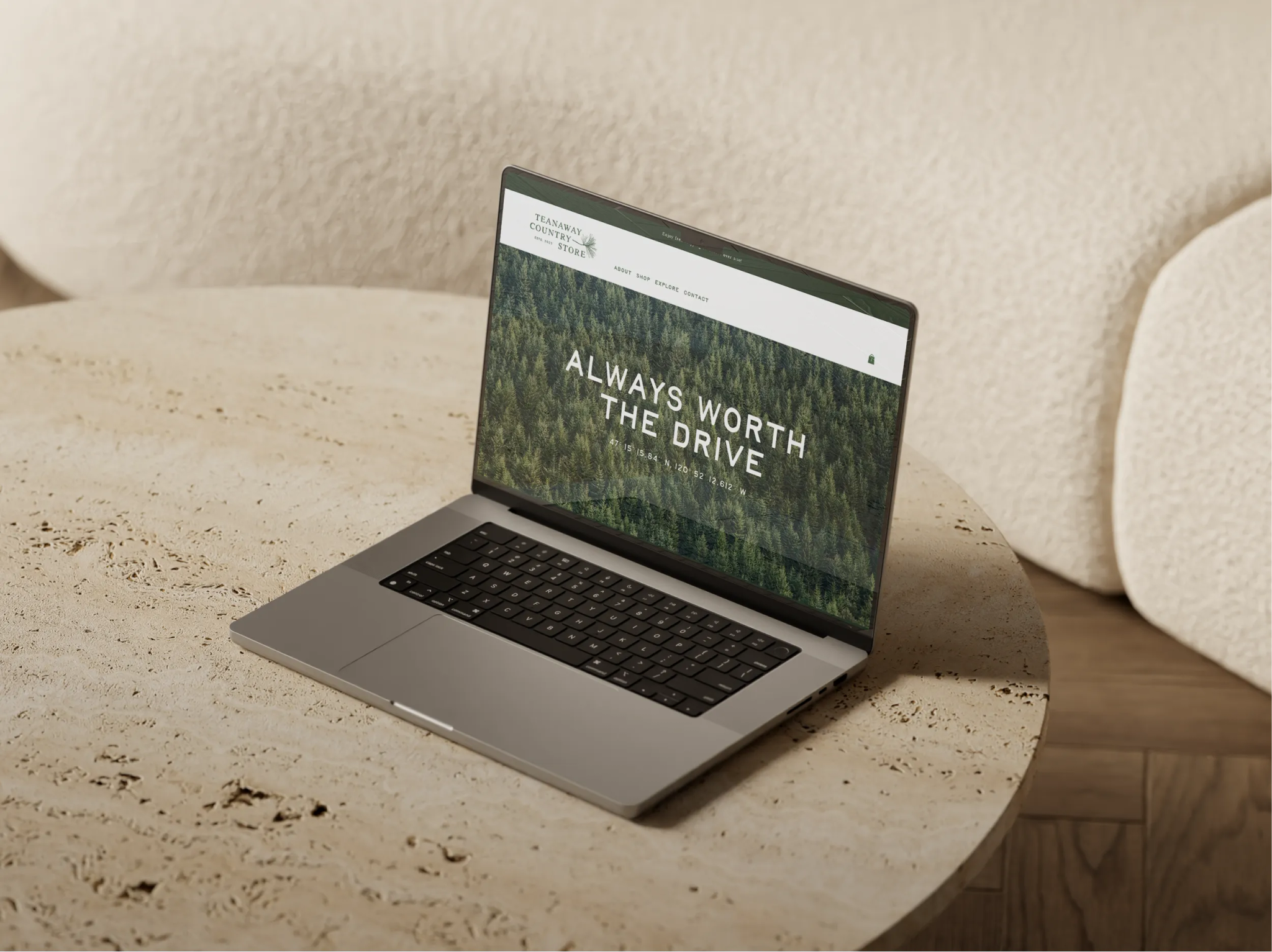 Laptop displaying the Teanaway Country Store website homepage, featuring the tagline 'Always Worth the Drive' over a forest photograph.