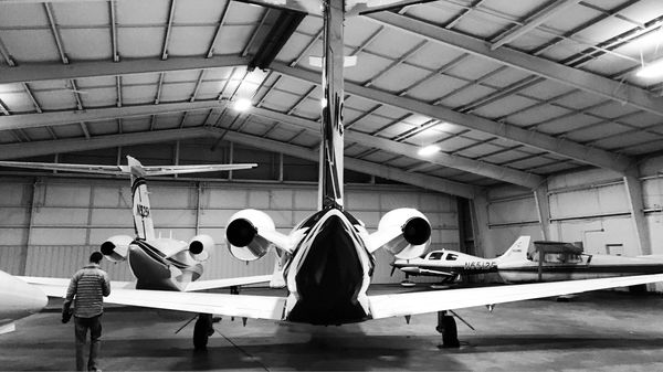 Private aircraft parked in a hangar.
