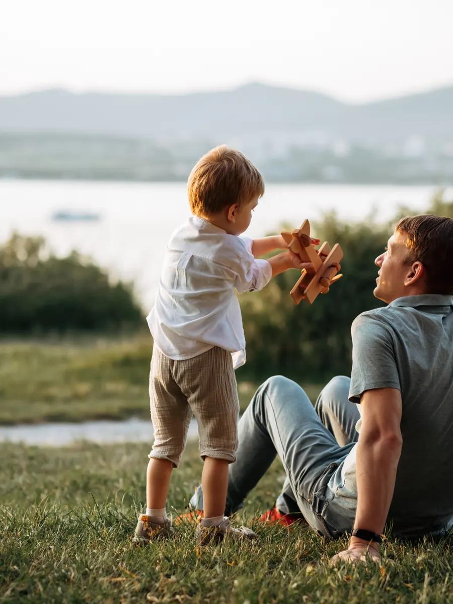 A father and son playing together at the edge of the water