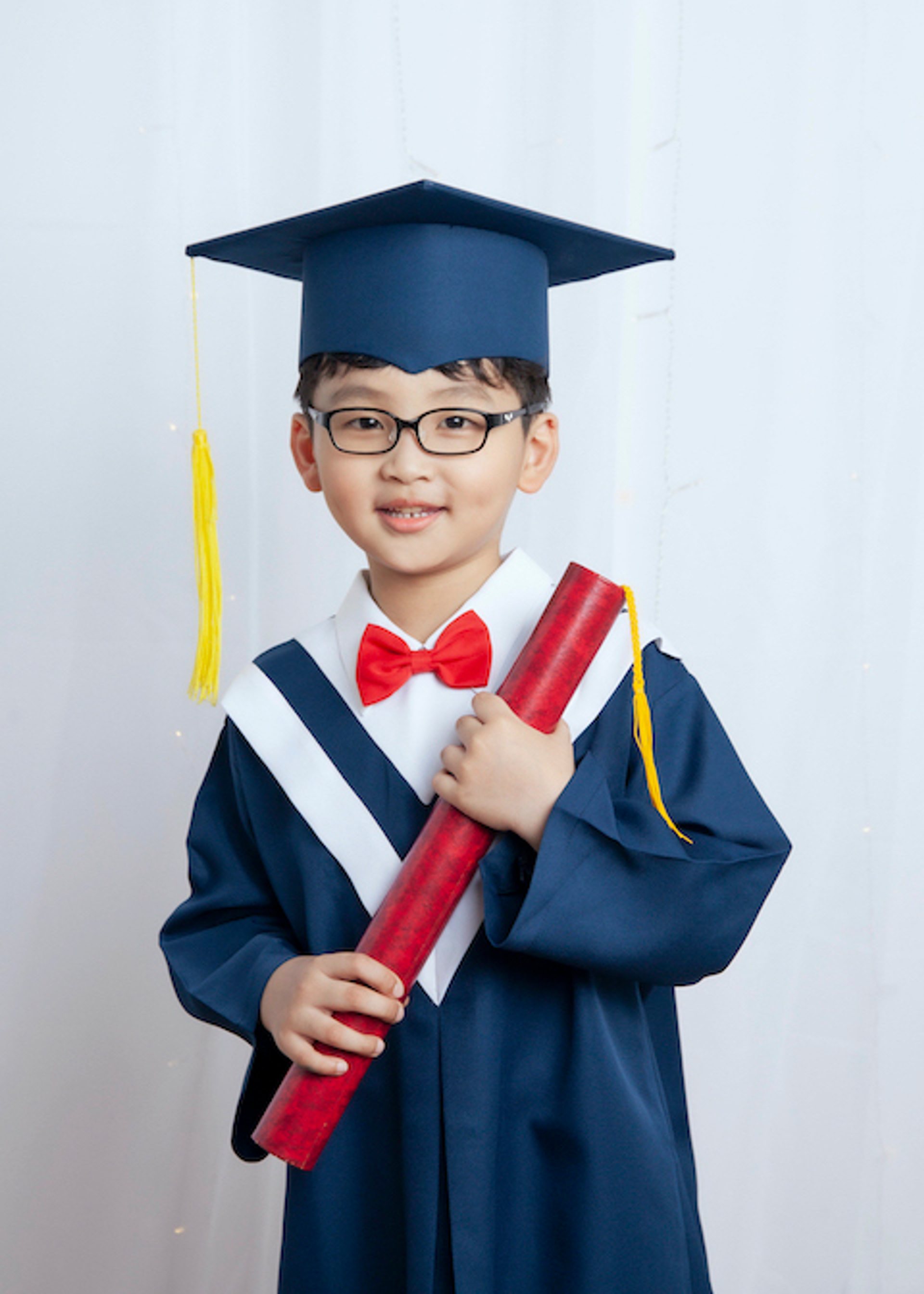 畢業寫真－深藍學士服眼鏡男童持紅色證書筒