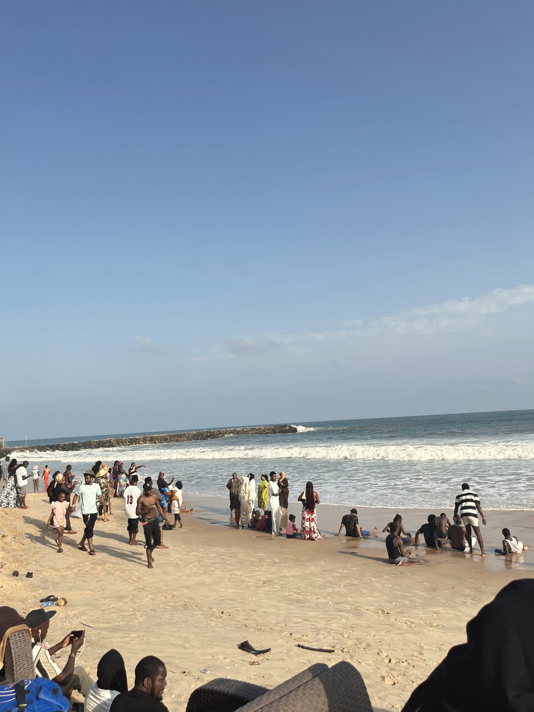 Guests along the shoreline at Wave Beach
