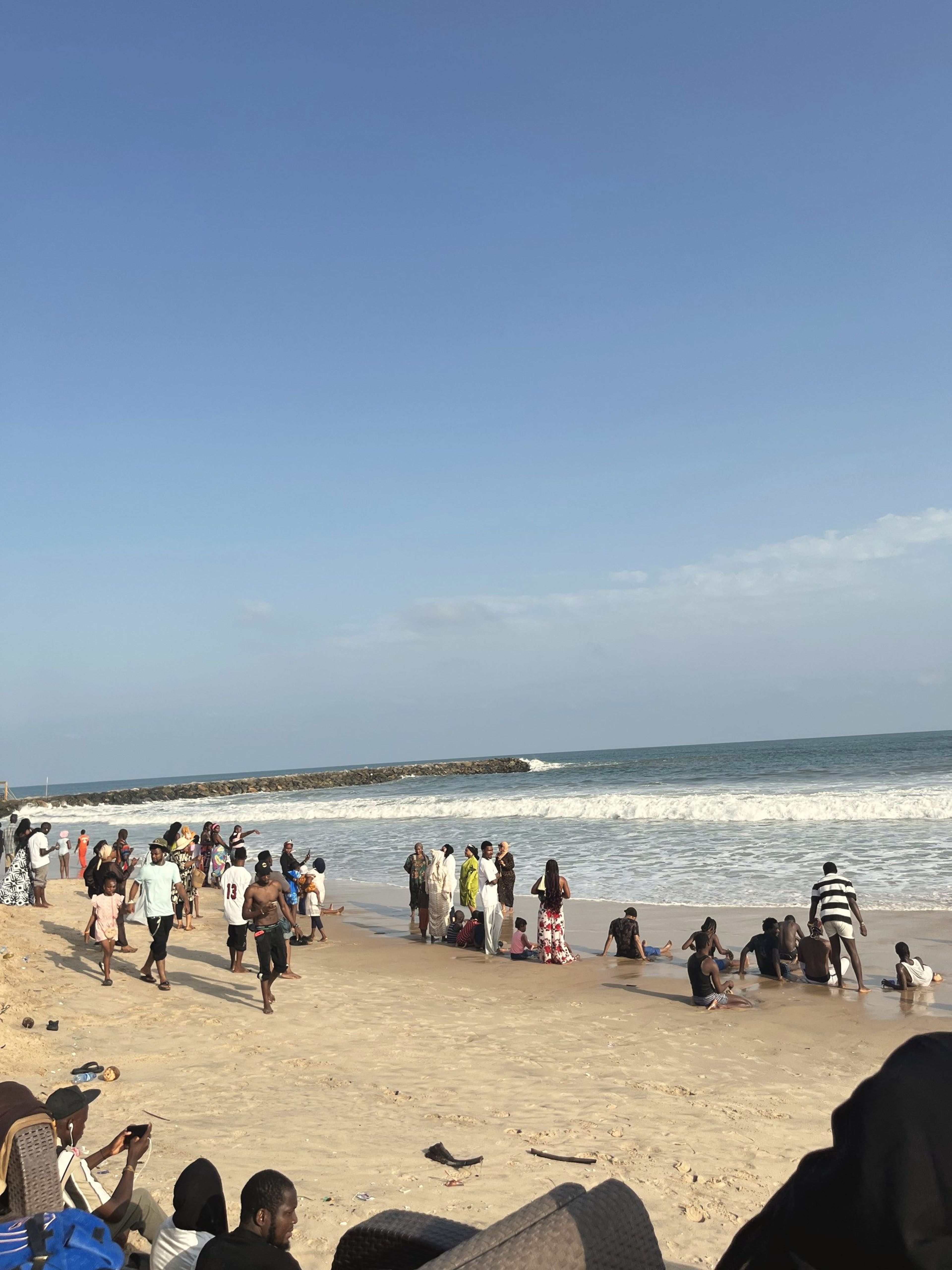 Guests along the shoreline at Wave Beach