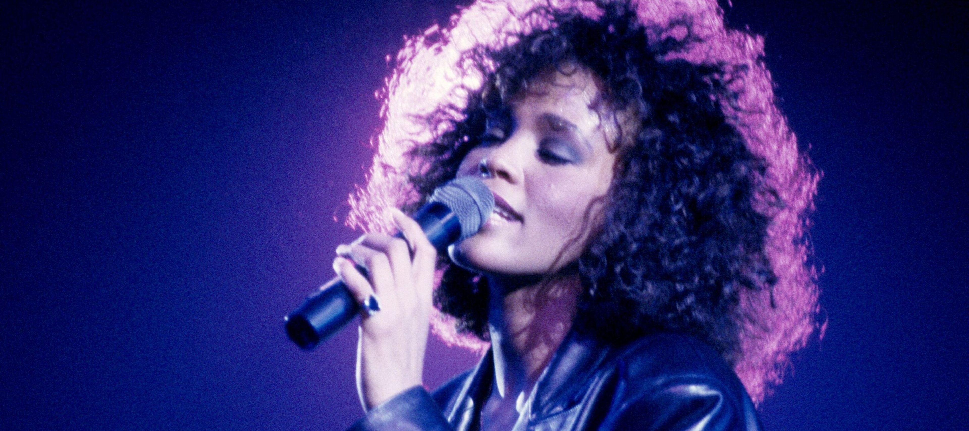 Whitney Houston singing into a microphone
