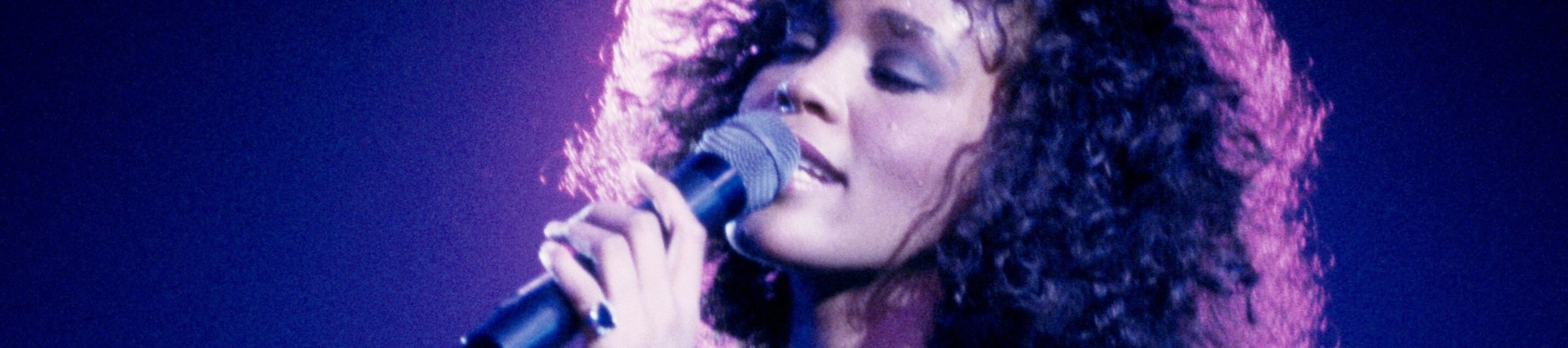 Whitney Houston singing into a microphone