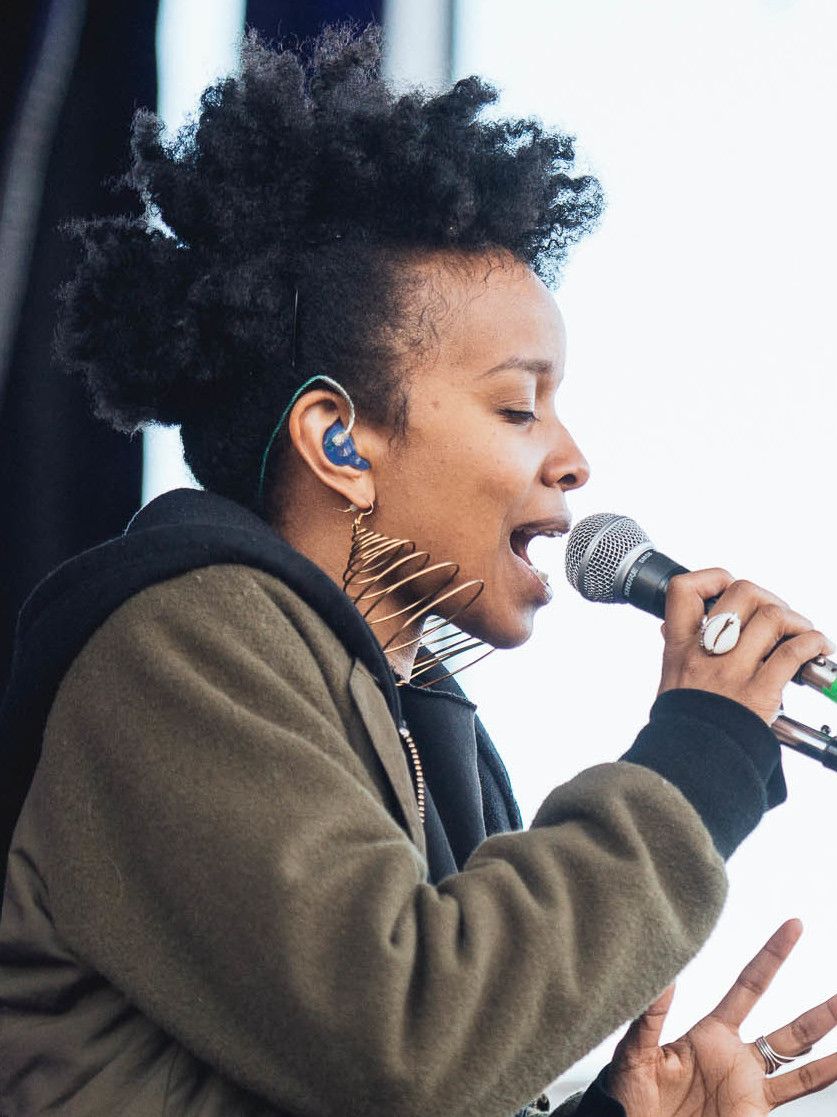Photo of singer Jamila Woods performing on stage