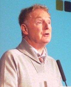 Malcolm McLaren speaking into a microphone