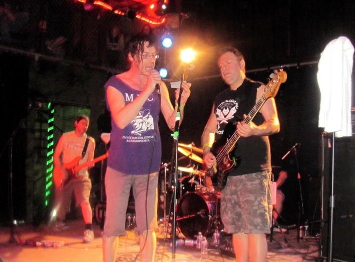 The punk band Subhumans performing live on stage in 2011.