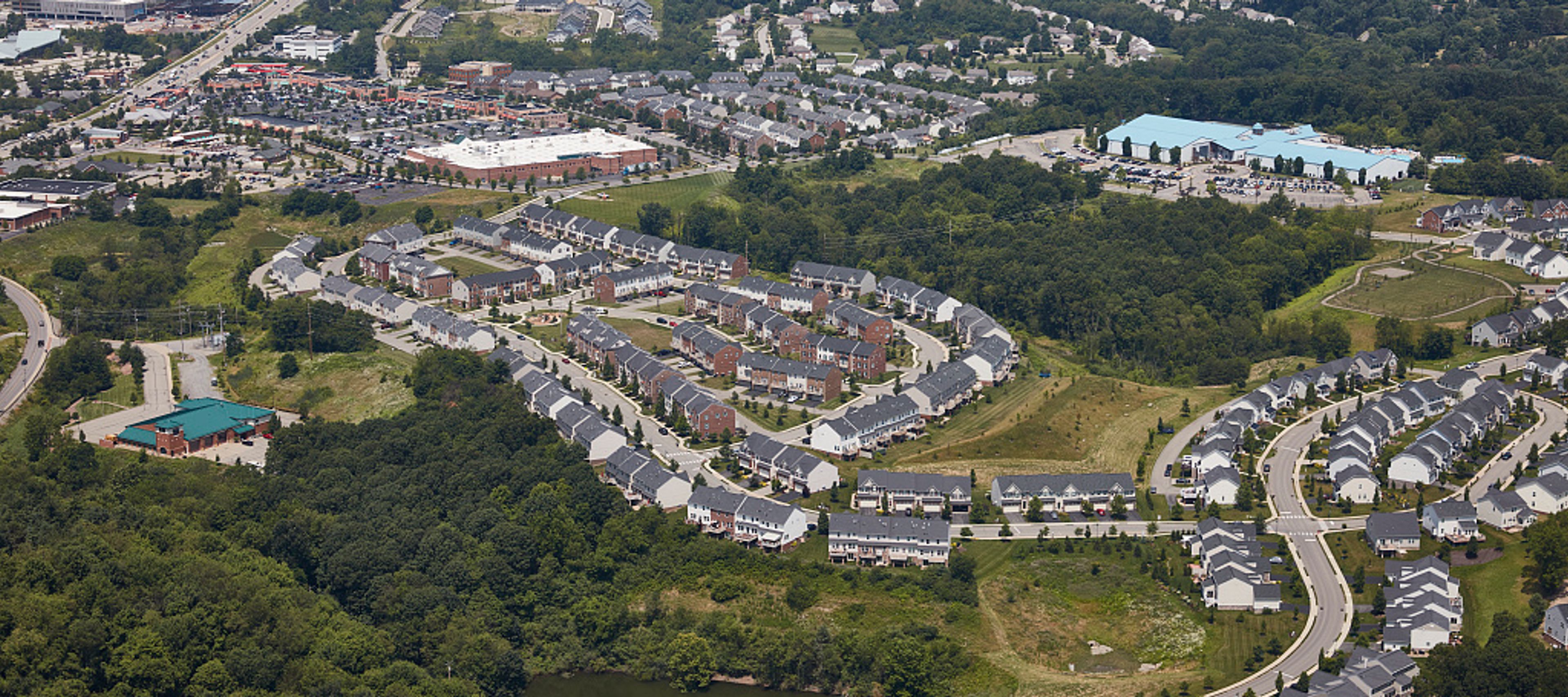 This is an aerial view capturing a suburban landscape characterized by a mix of residential and commercial development.