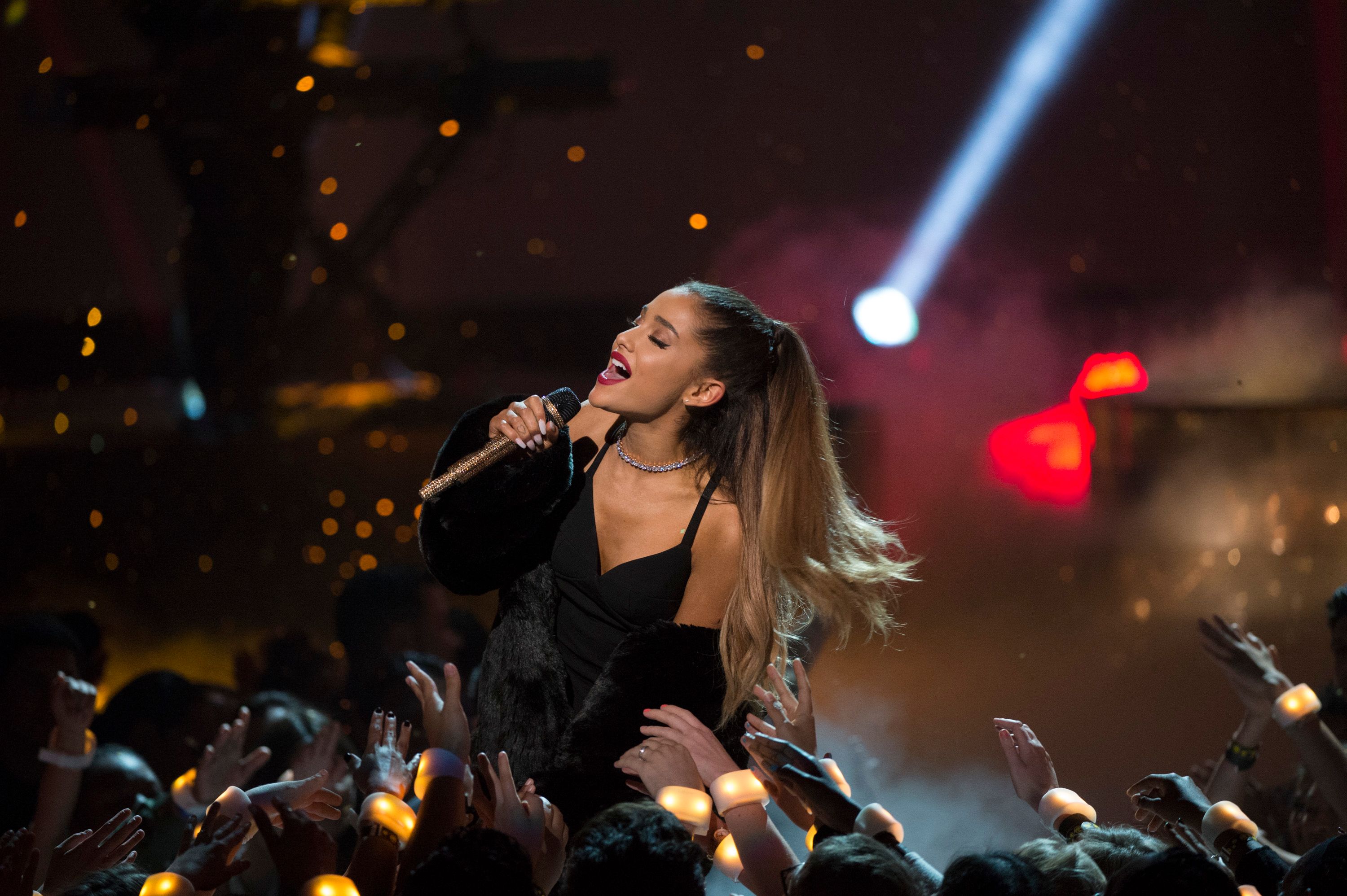 Ariana Grande singing into a microphone