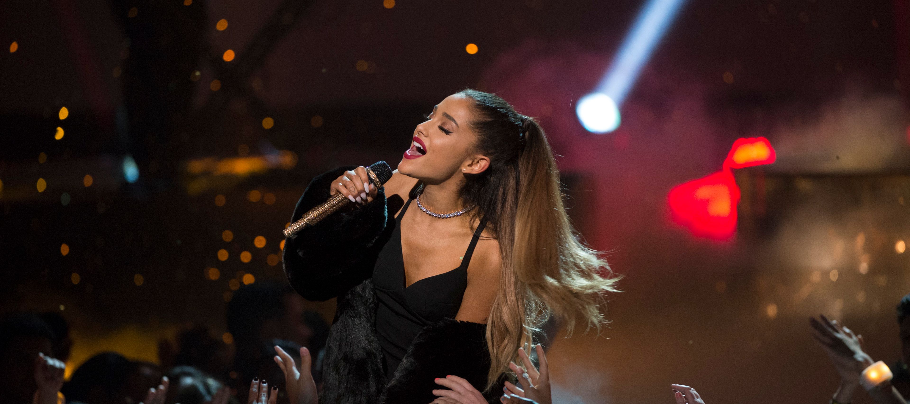 Ariana Grande singing into a microphone