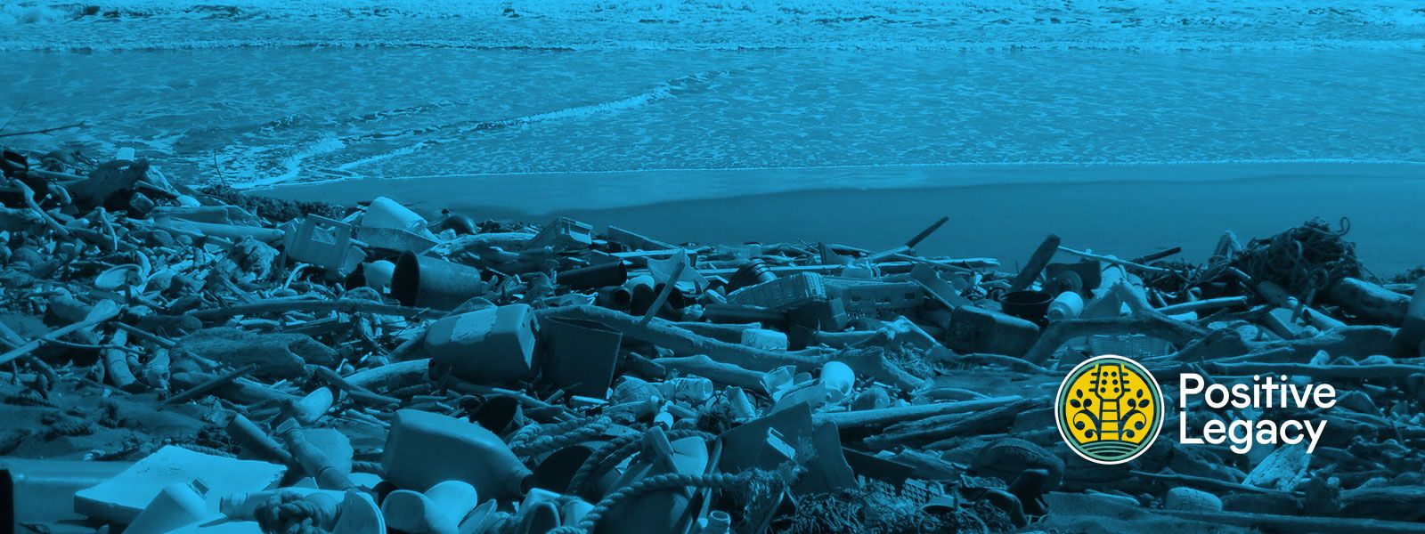 A wide, landscape-oriented image with a heavy blue tint, showing a beach covered in a significant amount of plastic pollution and debris.