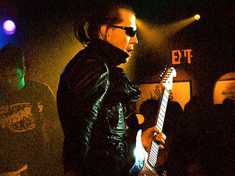 Link Wray playing guitar on stage in 2003