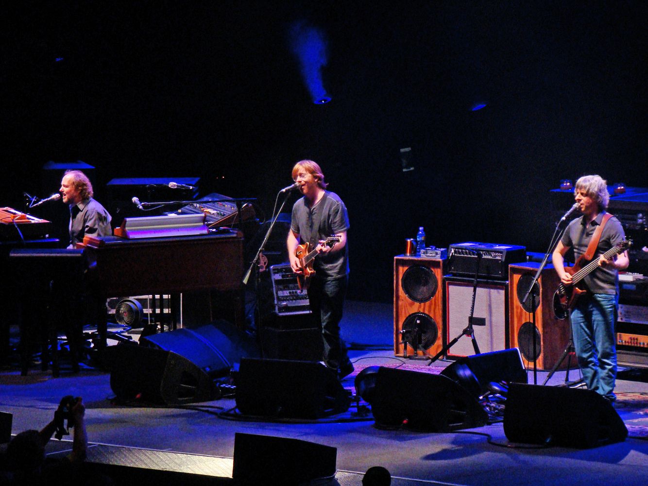 Members of the band Phish performing live on stage in 2009.