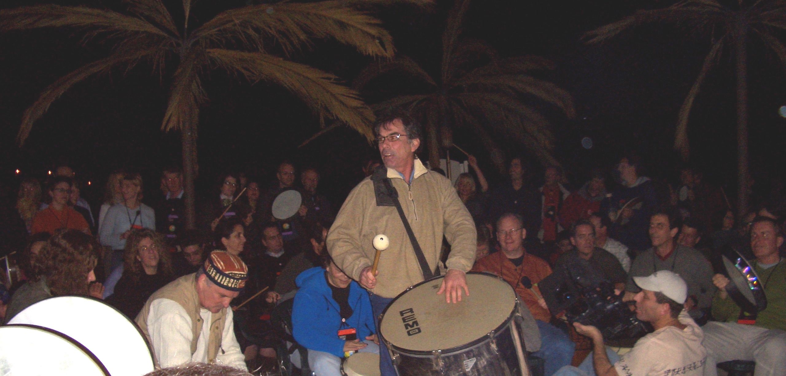 Mickey Hart drumming and leading a group drum circle outdoors