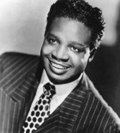 Black and white publicity portrait of singer Roy Brown.