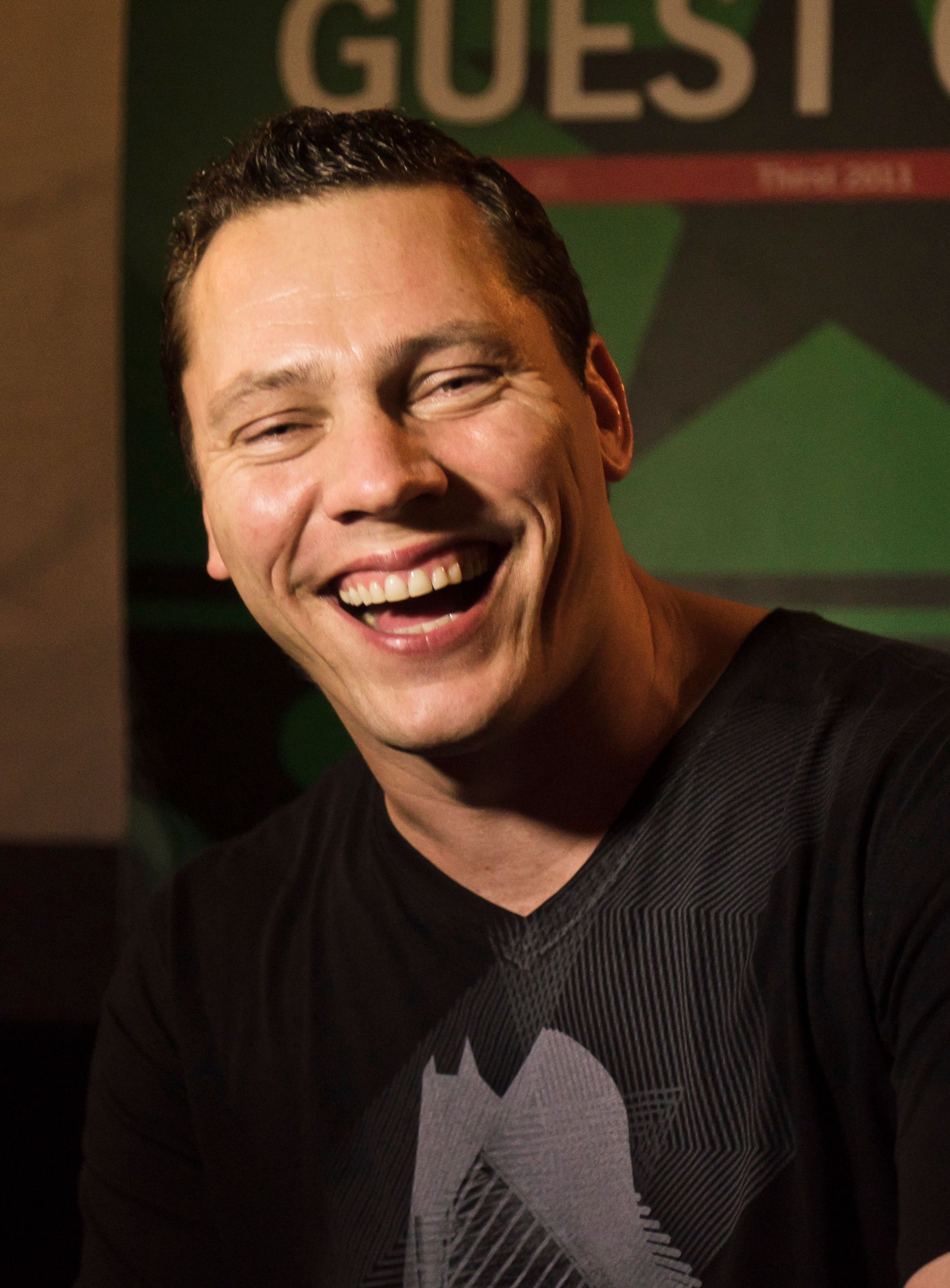 DJ Tiësto performing at a turntable in 2011