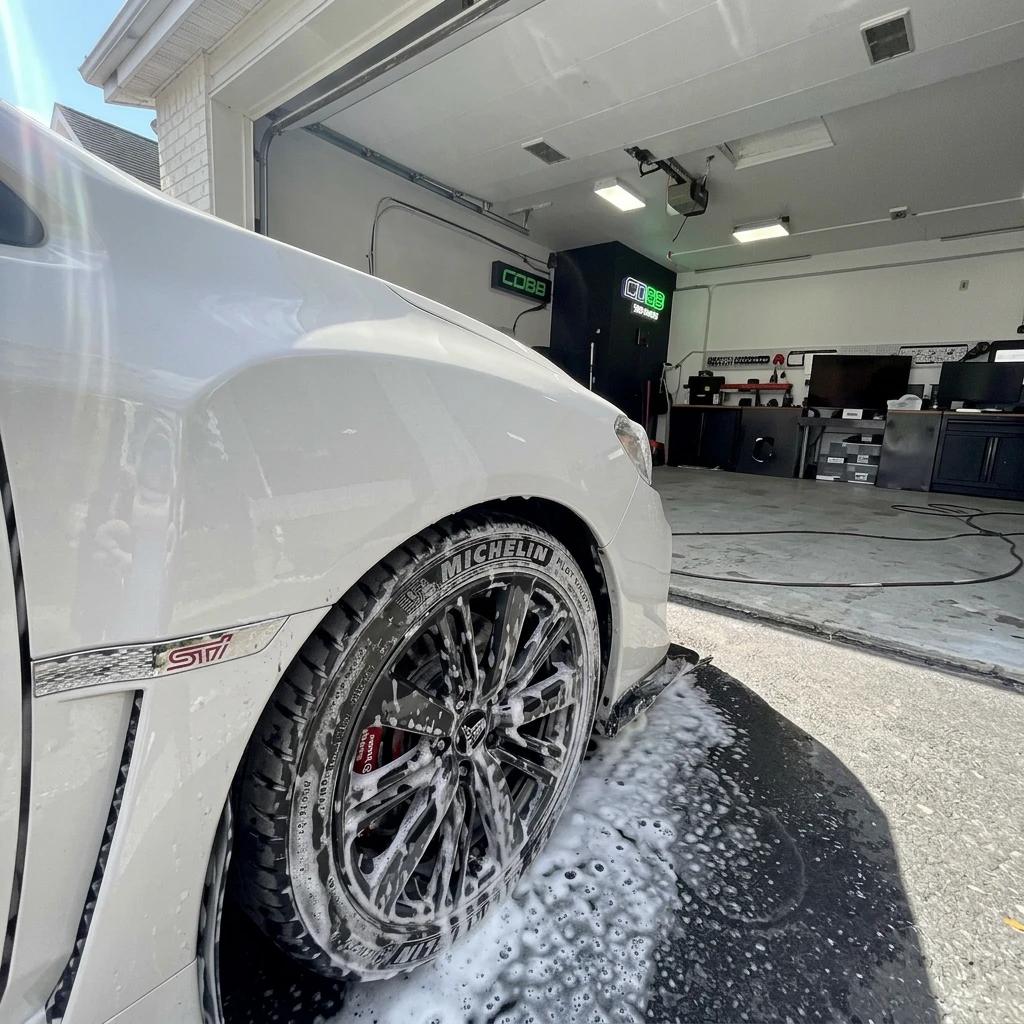 Wheel Cleaning White Luxury Car — professional auto detailing work completed at Fresh Auto Spa in Port Chester, NY