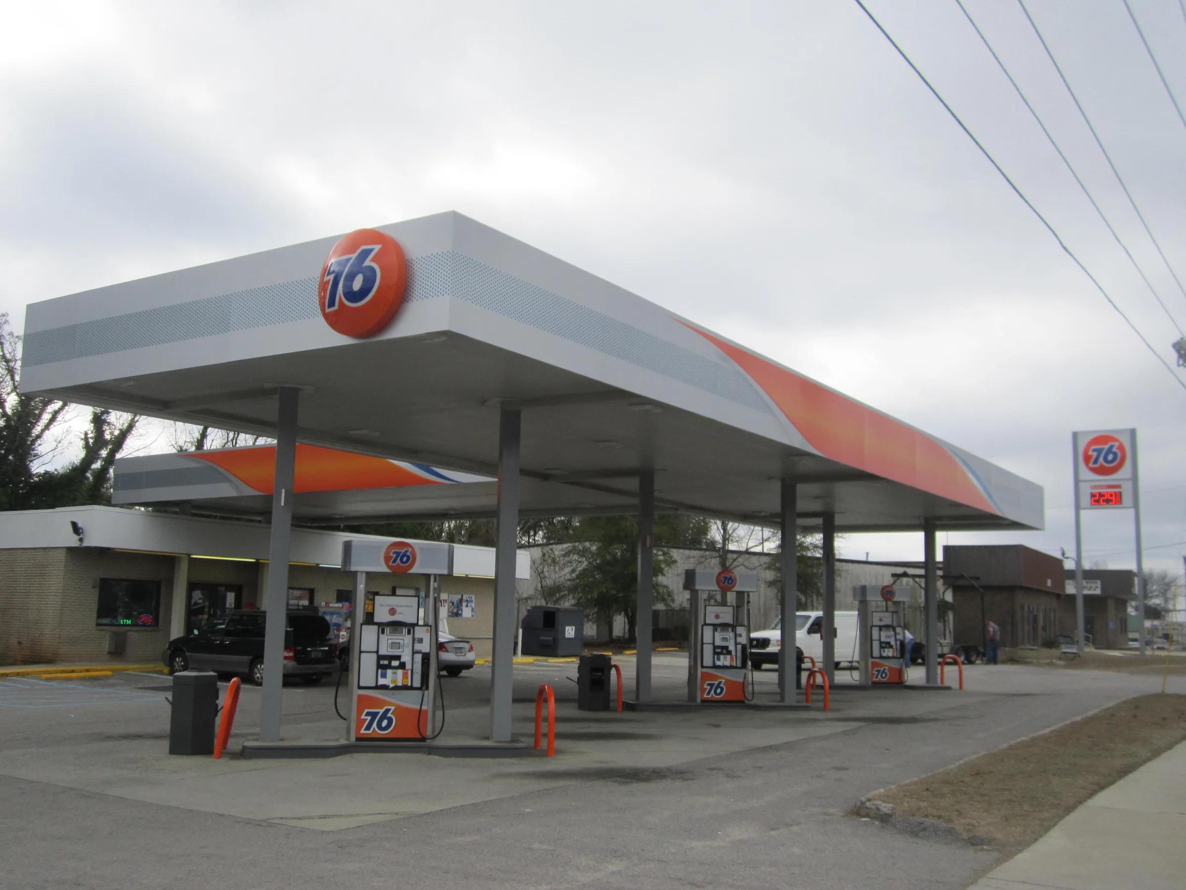 76 canopy with a grey and orange fascia and a 76 ball sign, a price sign at the roadside