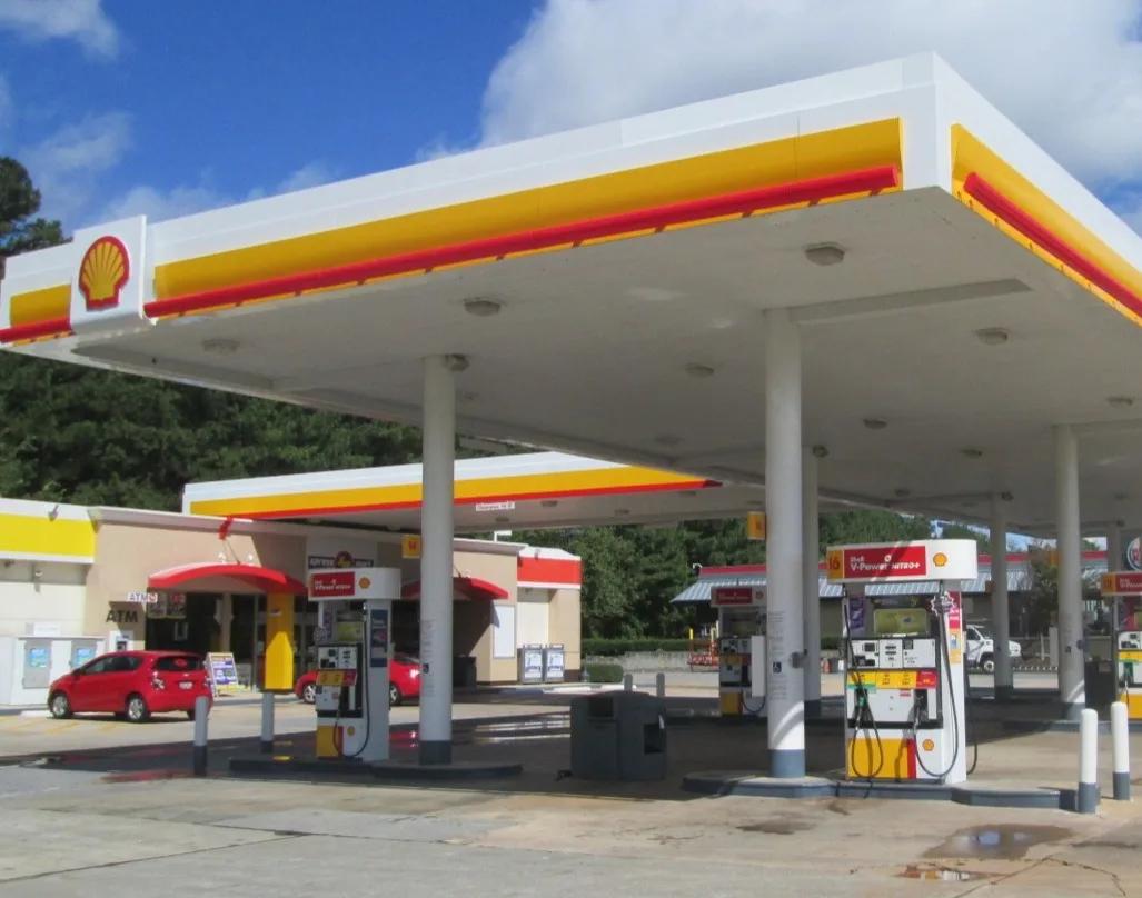 Shell canopy with a red and yellow fascia over a row of dispensers, a second canopy behind
