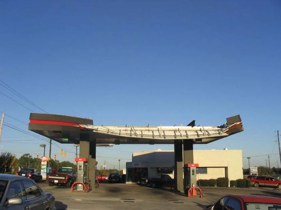 Fuel canopy with its fascia and deck torn open by storm damage