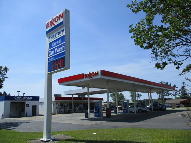 Exxon pylon price sign with diesel and car wash panels, an Exxon canopy behind it