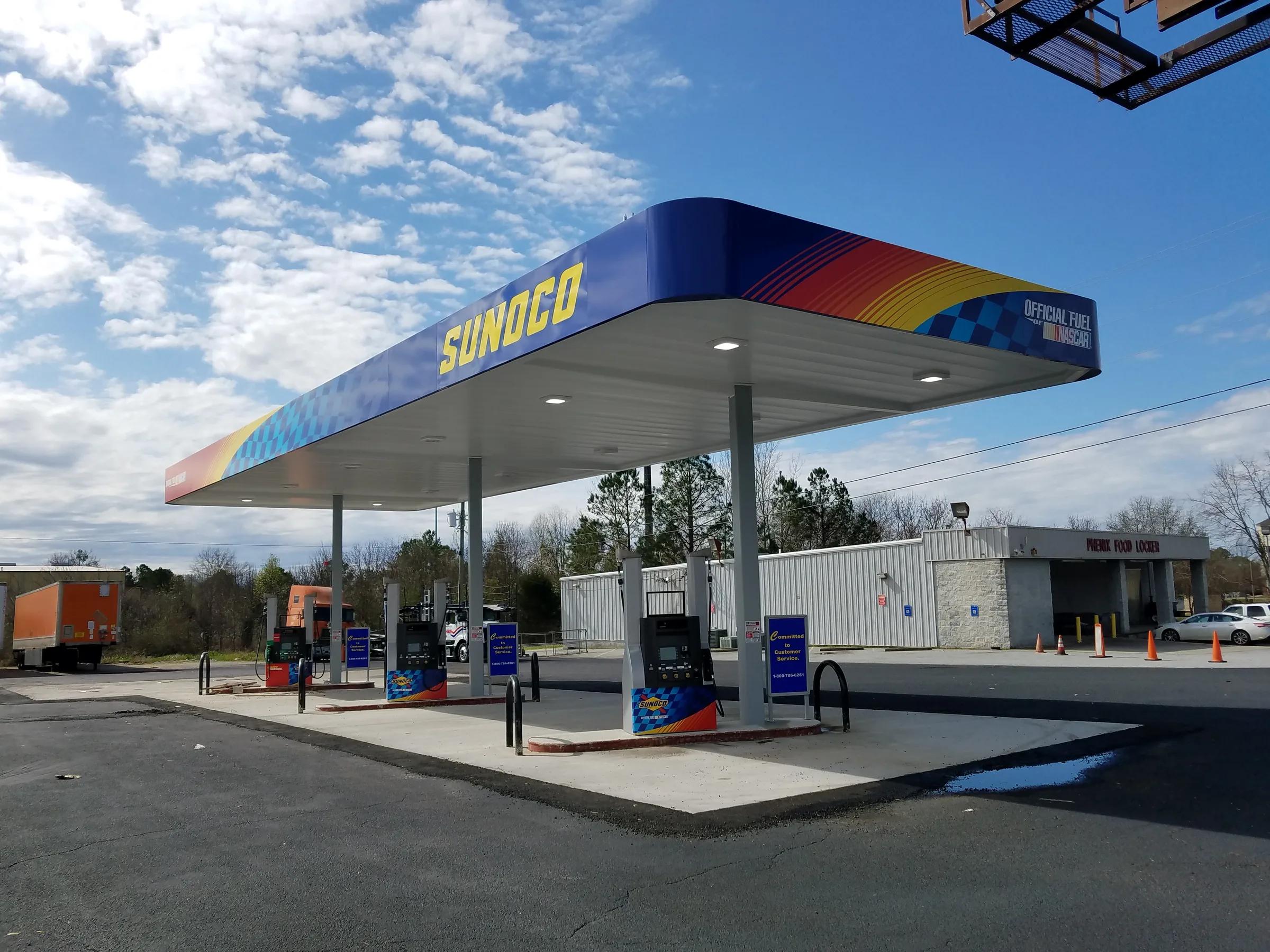 Sunoco canopy with a blue and checkered fascia over dispensers