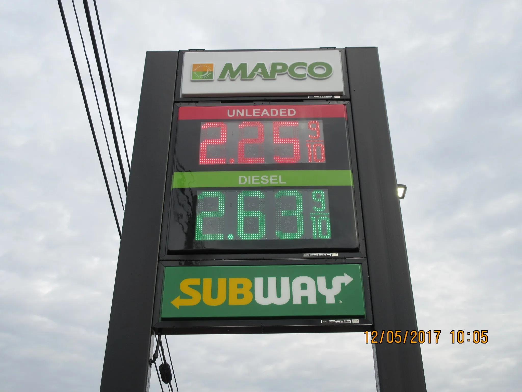 Mapco pylon price sign with red and green LED price numerals and a restaurant panel