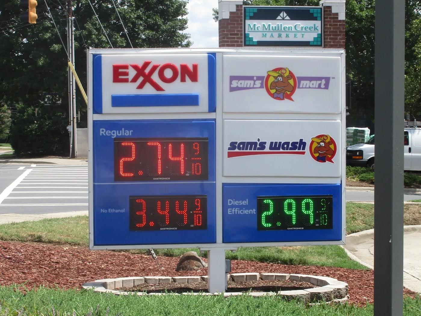 Exxon price sign with red and green LED price numerals and a car wash panel