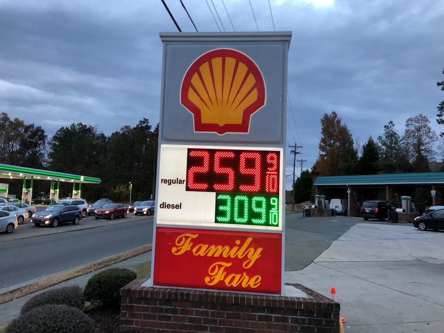 Shell monument price sign at dusk with red and green LED price numerals