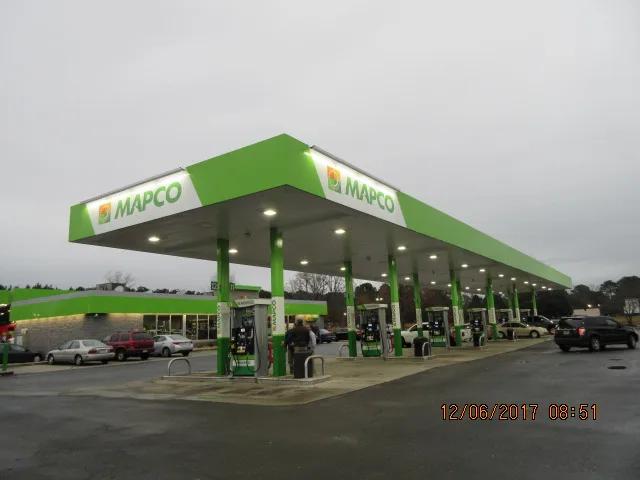 Mapco canopy with a green fascia and Mapco signs over a long row of dispensers