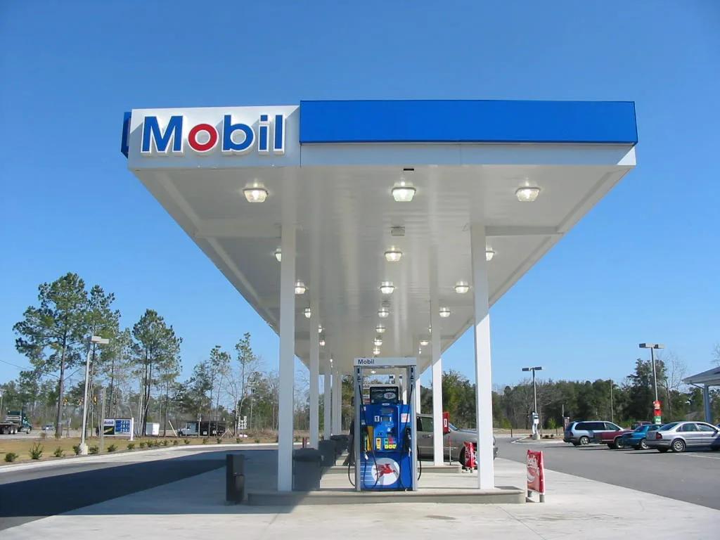 Mobil canopy with a blue fascia and recessed lights over dispensers on a new concrete forecourt
