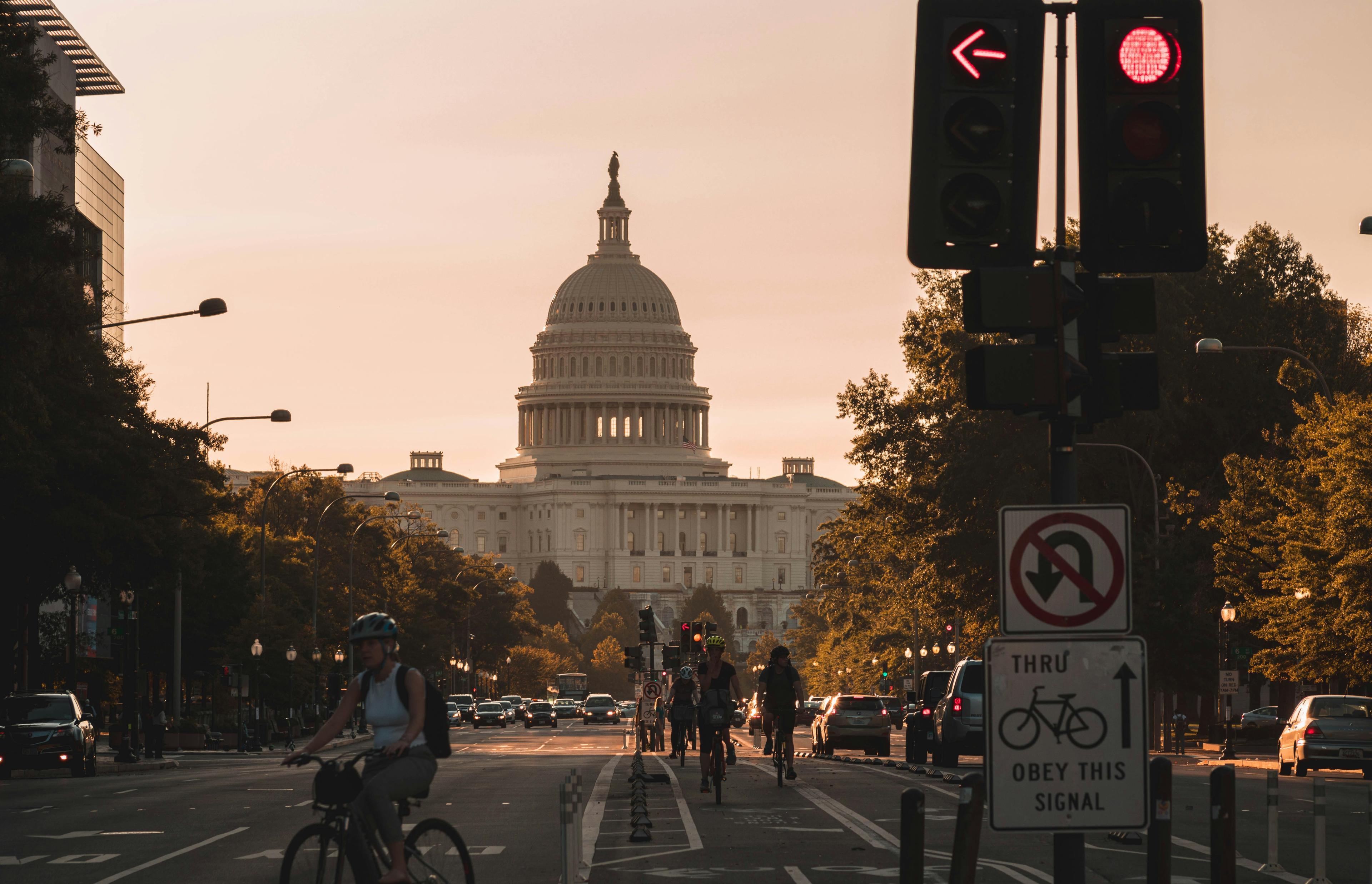 Federal government building and busy streets at sunset