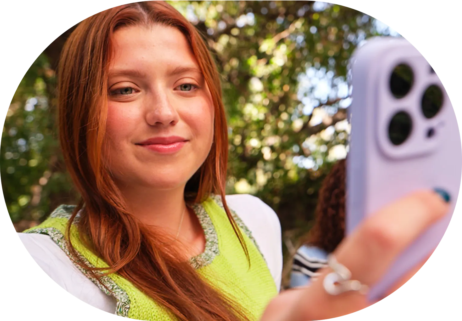 Student holding up a phone outdoors