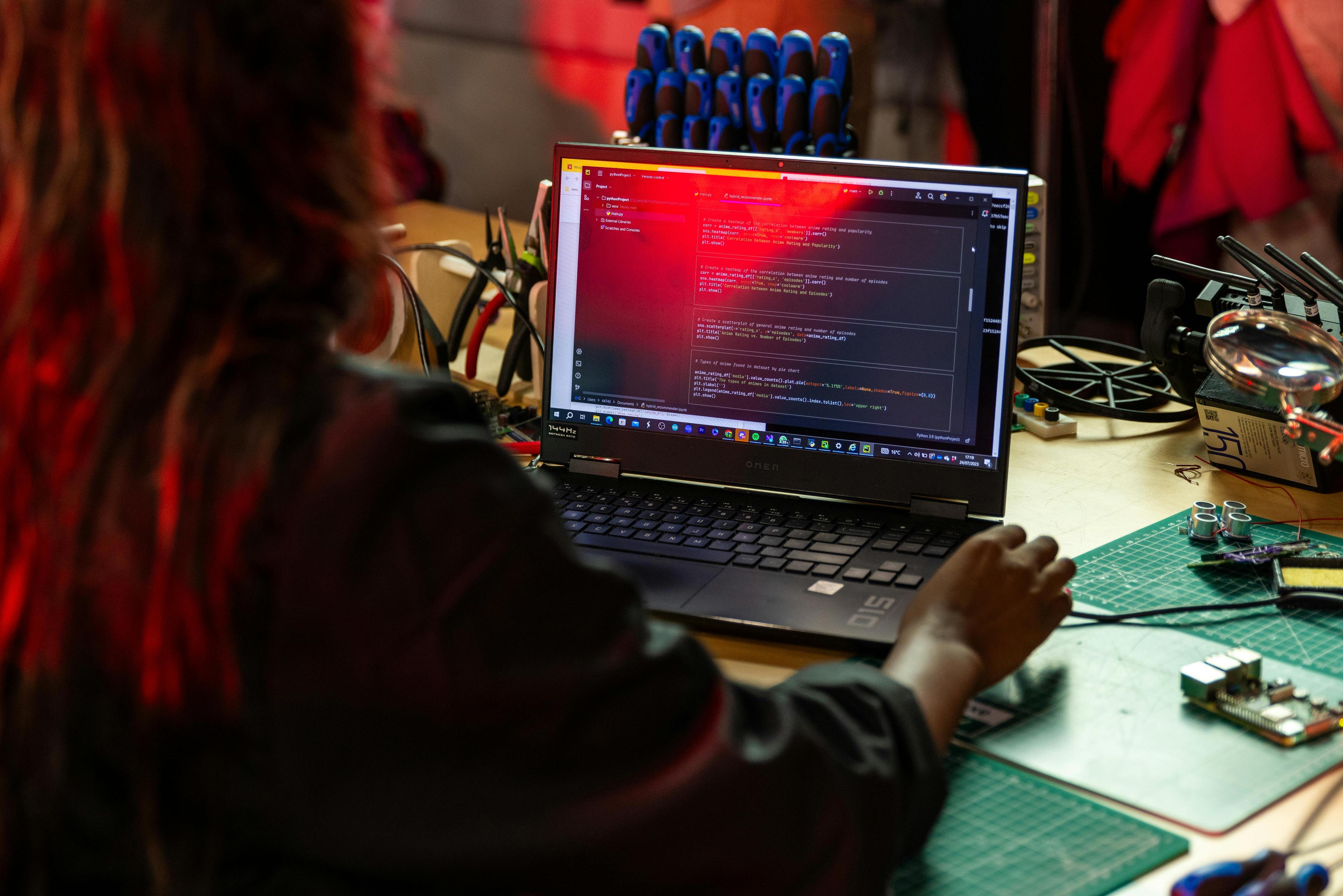 the back of a person looking at code on a latptop.