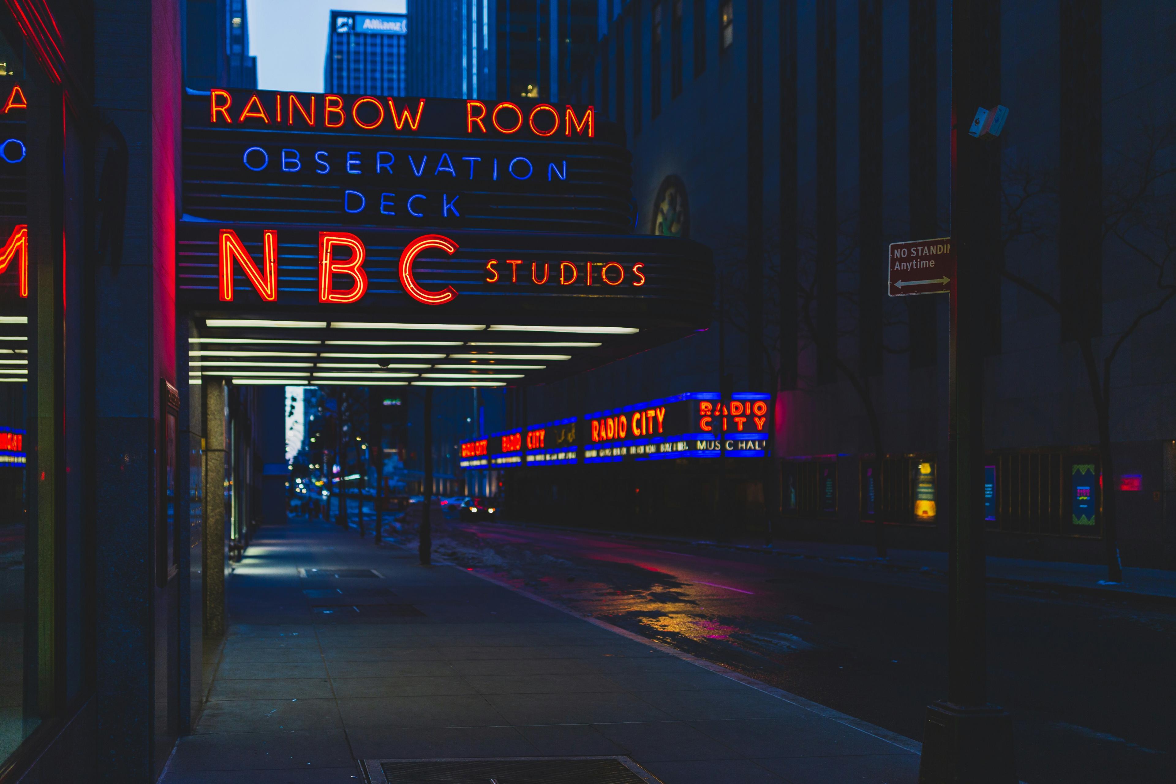 Evening shot of NBC Studios neon sign on East 50th St in New York City.