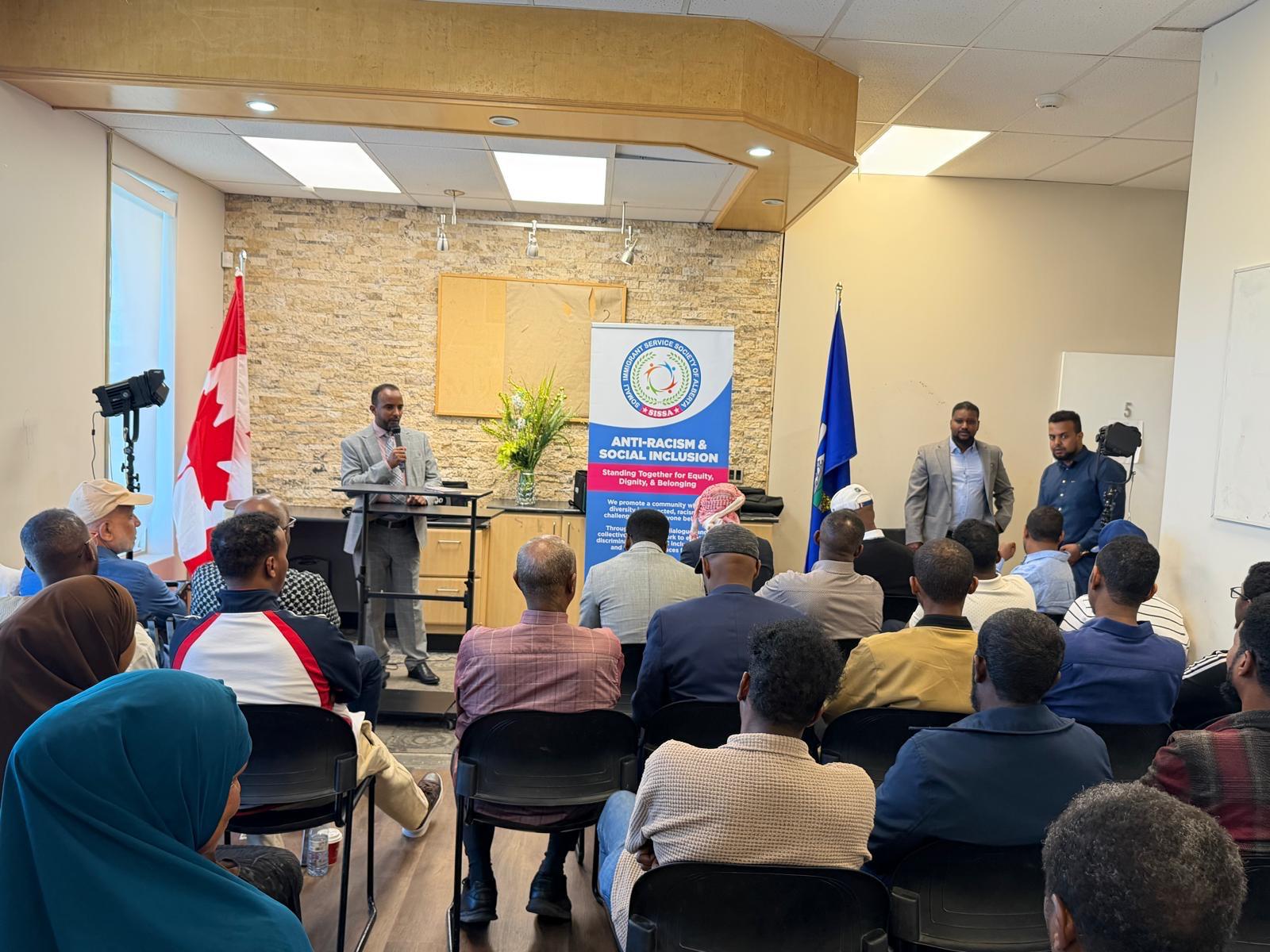 A speaker addresses community members at a SISSA Anti-Racism and Social Inclusion session.