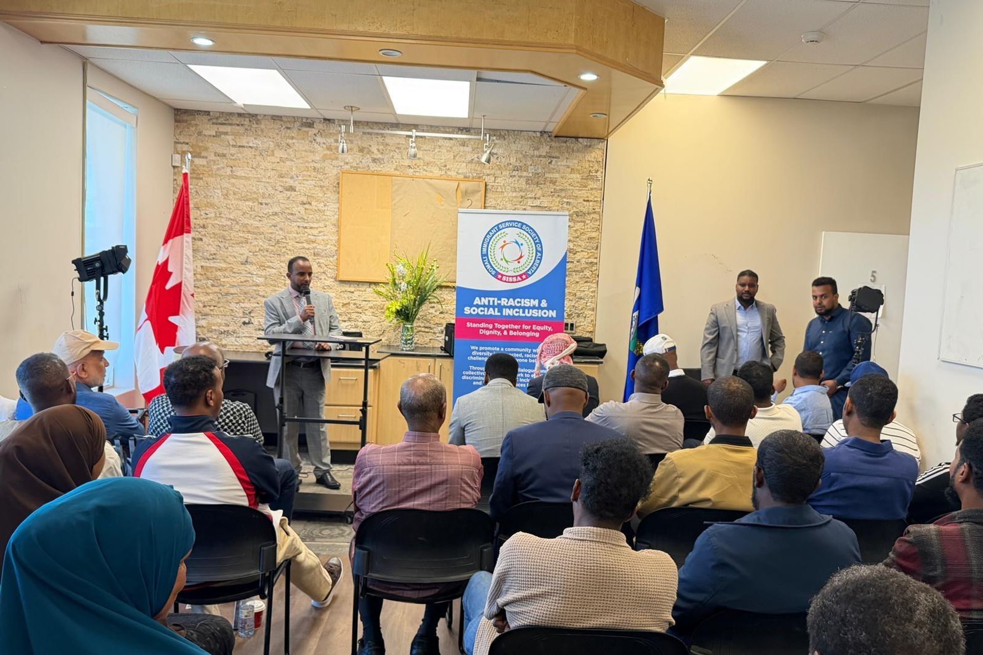 A speaker addresses community members at a SISSA Anti-Racism and Social Inclusion session.