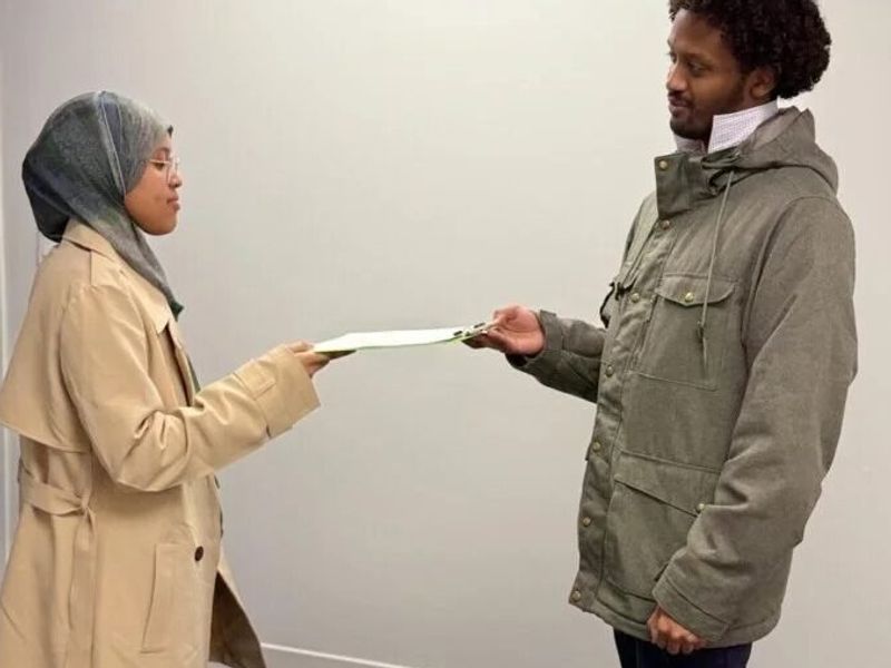A SISSA settlement worker meeting with a newcomer family in Edmonton.
